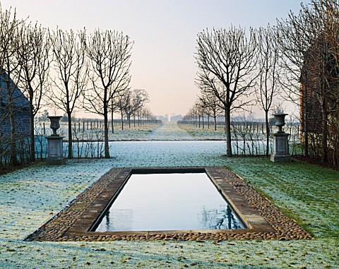 THE_MAIN_WEST_FACING_AXIS_WITH_THE_RECTANGULAR_SWIMMING_POOL_FRAMED_BY_CLIPPED_HORSE_CHESTNUT_TREES_