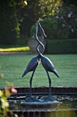 MARINERS GARDEN  BERKSHIRE. DESIGNER FENJA ANDERSON - VIEW INTO THE ROSE GARDEN TO THE WATER LILY POOL WITH HERON SCULPTURE