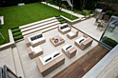 URBAN CONTEMPORARY MODERN MINIMALIST GARDEN DESIGNED BY CHARLOTTE SANDERSON: VIEW ONTO PATIO WITH TABLE AND CHAIRS AND STEPS UP TO LAWN