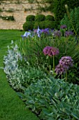THE OLD RECTORY  HASELBECH  NORTHAMPTONSHIRE - BORDER BESIDE A LAWN WITH ALLIUM CHRISTOPHII  IRIS JANE PHILLIPS AND STACHYS