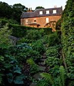 THE OLD RECTORY  HASELBECH  NORTHAMPTONSHIRE - VIEW OF THE OLD RECTORY FROM THE SHADE GARDEN PLANTED WITH HOSTAS AND FERNS