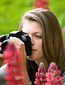 GIRL WITH CAMERA IN A GARDEN