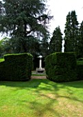 SUNDIAL BY DAVID HARBER SEEN THROUGH A YEW HEDGE
