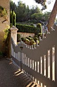 DESIGNER DOMINIQUE LAFOURCADE  PROVENCE  FRANCE -  ORNATE BLUE WOODEN GATE IN EARLY MORNING LIGHT