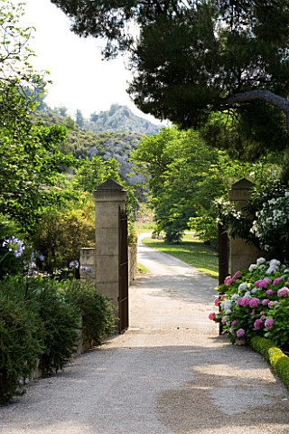 DESIGNER_DOMINIQUE_LAFOURCADE__PROVENCE__FRANCE__THE_MAIN_ENTRANCE_WITH_VIEWS_OF_HILLS_BEYOND