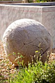 PROVENCE  FRANCE. GARDEN OF MARCO NUCERA. GRAVEL GARDEN WITH BEAUTIFUL WOODEN SCULPTURED BALL IN FRONT OF CONCRETE WATER BASIN