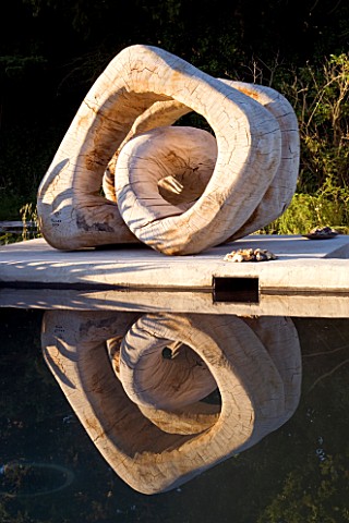 PROVENCE__FRANCE_GARDEN_OF_MARCO_NUCERA_BEAUTIFUL_WOODEN_SCULPTURE_REFLECTED_IN_WATER_TROUGH_WATER_F