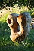 PROVENCE  FRANCE. GARDEN OF MARCO NUCERA. BEAUTIFUL WOODEN SCULPTURE IN GRASS
