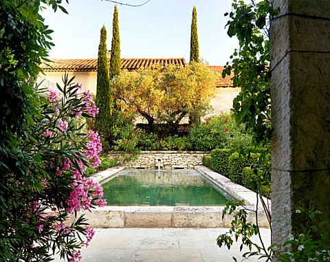 DESIGNER_MICHEL_SEMINI__PROVENCE__FRANCE_LIMESTONE_POOL_WITH_WATER_SPOUT_IN_THE_EVENING