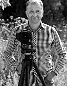 CLIVE NICHOLS IN HIS GARDEN WITH MANFROTTO 058B TRIPOD AND 410 GEARED HEAD - BLACK AND WHITE IMAGE