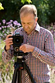 CLIVE NICHOLS IN HIS GARDEN WITH MANFROTTO 058B TRIPOD AND 410 GEARED HEAD