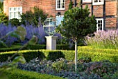 DAVID HARBER SUNDIALS: FRONT GARDEN WITH ARMILLARY SPHERE SUNDIAL  FORMAL BOX BEDS WITH PURPLE SAGE  PEROVSKIA AND LAVENDER WITH STANDARD HOLLY TREE (ILEX)