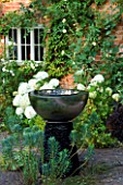 DAVID HARBER SUNDIALS: CHALICE WATER FEATURE/SUNDIAL MADE FROM MIRROR POLISHED STAINLESS IN FRONT GARDEN