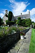 THROUGHAM COURT  GLOUCESTERSHIRE. DESIGNER: CHRISTINE FACER: THE HOUSE FROM THE MAIN LAWN WITH TOPIARY SHAPES