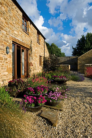 RICKYARD_BARN__NORTHAMPTONSHIRE_VIEW_OF_THE_RICKYARD_WITH_THE_BARN_AND_CONTAINERS_ON_TERRACE