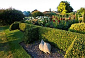 PETTIFERS GARDEN  OXFORDSHIRE: THE PARTERRE IN AUTUMN PLANTED WITH DAHLIAS. IN FOREGROUND IS SCULPTURE BY BRIONY LAWSON
