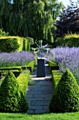DAVID HARBER SUNDIALS: PATH TO SUNDIAL SURROUNDED BY BOX HEDGES AND LAVENDER. EVENING LIGHT