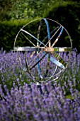 DAVID HARBER SUNDIALS: STAINLESS STEEL ARMILLARY SPHERE SUNDIAL SURROUNDED BY BOX HEDGES AND LAVENDER. EVENING LIGHT