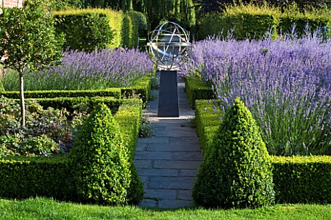 DAVID_HARBER_SUNDIALS_STONE_PATH_WITH_STAINLESS_STEEL_ARMILLARY_SPHERE_SUNDIAL_IN_FORMAL_GARDEN_SURR