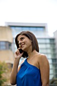 TEENAGE GIRL (16-17 YEARS) IN BLUE TOP TALKING ON MOBILE PHONE  SMILING  TEENAGE GIRLS  ONE TEENAGE GIRL ONLY  CASUAL CLOTHING  HAPPY  HAPPINESS  STUDENT  COLLEGE  ON THE PHONE