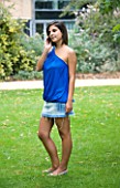 TEENAGE GIRL (16-17 YEARS) IN BLUE TOP TALKING ON MOBILE PHONE  SMILING  TEENAGE GIRLS  ONE TEENAGE GIRL ONLY  CASUAL CLOTHING  HAPPY  HAPPINESS  STUDENT  COLLEGE  ON THE PHONE