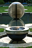 DAVID HARBER SUNDIALS: CHALICE WATER FEATURE AND ETHER WATER FEATURE IN A POOL IN EARLY MORNING DAWN LIGHT