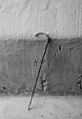 SUITE.DO. BLACK AND WHITE IMAGE OF A WALKING STICK AGAINST A WALL IN MALLORCA  SPAIN