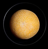 MELON IN A BLACK BOWL WITH BLACK BACKGROUND