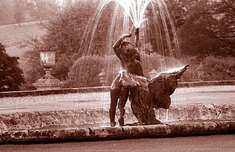 CASTLE_HILL__DEVON_BLACK_AND_WHITE_TONED_IMAGE_OF_A_FOUNTAIN_BESIDE_THE_HOUSE