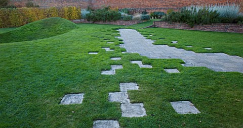MARKS_HALL__ESSEX___A_STONE_PATH_IN_THE_WALLED_GARDEN_WITH_THE_EARTH_SCULPTURE_IN_THE_BACKGROUND_AND