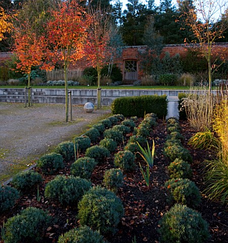 MARKS_HALL__ESSEX_AUTUMN_COLOUR_IN_THE_WALLED_GARDEN__THE_GARDEN_OF_SPHERES_WITH_WOODEN_GATE_IN_WALL