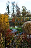 MARKS HALL  ESSEX : AUTUMN COLOUR IN THE WALLED GARDEN - VIEW PAST BEECH HEDGE TO THE POOL AND THE BIRKETT LONG MILLENIUM WALK