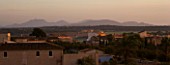 SUITE.DO. DAWN SUNLIGHT ON ROOFTOPS AND ALMOND TREES. SES SALINAS. MALLORCA  SPAIN