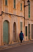 SUITE.DO. OLD WOMAN WALKING ALONG THE STREET. SANTANYI. MALLORCA  SPAIN
