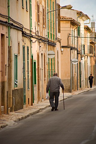 SUITEDO_OLD_MAN_WALKING_ALONG_THE_STREETS_SANTANYI__MALLORCA__SPAIN