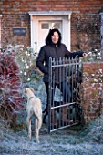 BOONSHILL FARM AT CHRISTMAS. OWNER LISETTE PLEASANCE OUTSIDE THE FRONT OF HER HOUSE IN FROST AT DAWN
