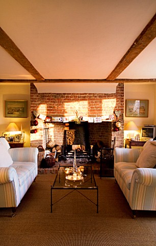 BOONSHILL_FARM_AT_CHRISTMAS_THE_LIVING_ROOM_WITH_SETTEES__FIREPLACE_AND_GLASS_COFFEE_TABLE_WITH_INDI