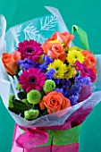 PINK BAG WITH CUT FLOWERS - GREEN AND YELLOW SHAMROCK CHRYSANTHEMUMS AND PINK GERBERAS