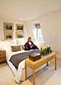 CHARLOTTE ROWES HOUSE - CHARLOTTES BEDROOM IN WHITE WITH CHARLOTTE AND HER CAT ON THE BED