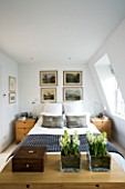 CHARLOTTE ROWES HOUSE - CHARLOTTES BEDROOM IN WHITE WITH  WHITE HYACINTHS IN CONTAINERS AT THE END OF THE BED