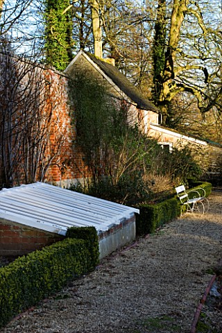 CERNEY_HOUSE__GLOUCESTERSHIRE_THE_OLD_WALLED_GARDEN_WITH_CLOCHE_AND_GREENHOUSE