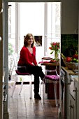 DESIGNER: CHARLOTTE ROWE  LONDON: CHARLOTTE SITTING IN HER DINING ROOM