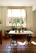 DESIGNERS SUE AYLETT: SUE AYLETTS HOUSE  LONDON: THE KITCHEN TABLE WITH VIEW OUT TO COURTYARD.