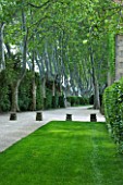 PROVENCE  FRANCE - ALTAVES. RECTANGULAR LAWN AND PATH WITH DECORATIVE STONE FEATURES LEAD TO AVENUE OF PLANE TREES