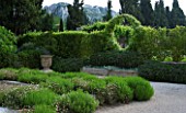 PRIVATE GARDEN  PROVENCE  FRANCE - DESIGNER DOMINIQUE LAFOURCADE. ARCH WITH SOLANUM JASMINOIDES WITH PROSTRATE ROSEMARY BELOW. DRY PLANTING OF ERIGERON KARVINSKIANUS AND ROSEMARY