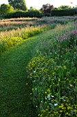 THE GRAY HOUSE  OXFORDSHIRE  DESIGNED BY TIM REES. A PATH THROUGH THE MEADOW IN SUMMER