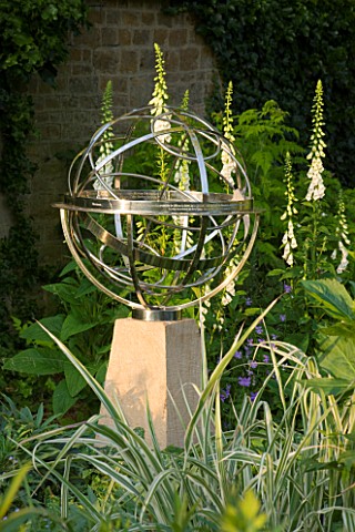 DAVID_HARBER_SUNDIALS_STAINLESS_STEEL__ARMILLARY_SPHERE_SUNDIAL_ON_A_STONE_PLINTH_AT_PETTIFERS__OXFO