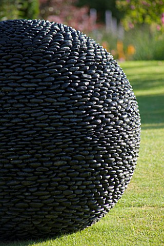 DAVID_HARBER_SUNDIALS_CLOSE_UP_OF_RIVER_POLISHED_PEBBLES_OF_THE_KERNAL_SCULPTURE_ON_LAWN_AT_PETTIFER