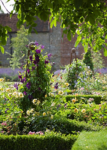 COWDRAY_WALLED_GARDEN__SUSSEX_DESIGNER_JAN_HOWARD_BOX_EDGED_BEDS_WITH_METAL_TRIPODSOBELISKS_AND_CLEM