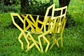 LA NORIA  FRANCE. GARDEN DESIGNED BY ARNAUD MAURIERES AND ERIC OSSART - SCULPTURES IN THE PRAIRIE DE SCULPTURES YELLOW METAL CHAIR